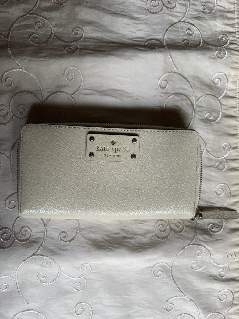 kate spade cream pebble leather zip wallet